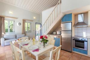 a kitchen and dining room with a table and chairs at Antigoni Beach House in Kounopetra