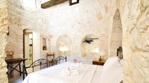 a bedroom with a bed in a stone wall at Borgo Miceli in Locorotondo