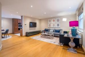 a living room with a couch and a table at ALTIDO Elegant house near Regent's Park in London