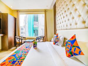 a hotel room with a bed and a window at FabHotel Diamond Zirakpur in Zirakpur