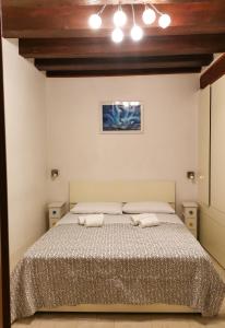 a bedroom with a bed with two pillows on it at Appartamento La Corte in Venice