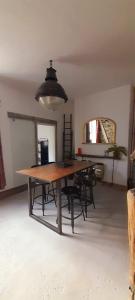 a dining room with a wooden table and chairs at Honestone Street hideaway in blissful Bideford in Bideford