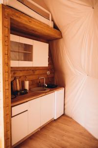 a kitchen in a tent with a sink at Mandra Hills in Richka