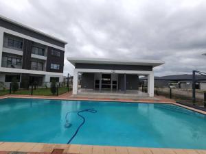 a large swimming pool in front of a building at StudioA102 Sarona in Broadhurst