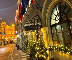 a building with a christmas tree on a street at St Palace Hotel in Vilnius