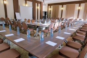 a long table in a room with chairs and water bottles at West Wood Hotel in Nairobi