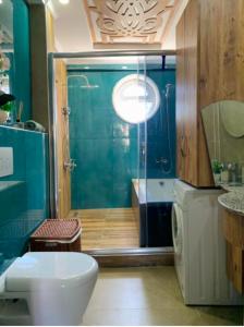 a bathroom with a shower and a toilet and a sink at Luxury Flat of Cleodora Residence in Serik