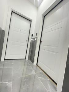 two white doors in a room with tile floors at B&B MANFREDI in Foggia