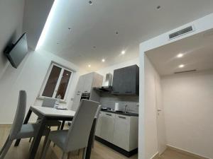 a kitchen with a table and chairs in a room at SUITE LUXURY MANFREDI - Centro in Foggia +5 photos