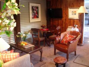 a living room filled with furniture and a table at Devon Long Barn in Bowral