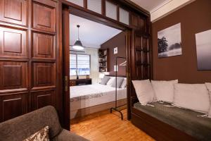 a bedroom with a bed and a couch in a room at Delmare Posidonio Apartment in Thessaloniki