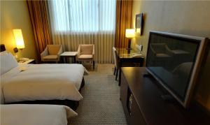 Postel nebo postele na pokoji v ubytování Taipei International Hotel