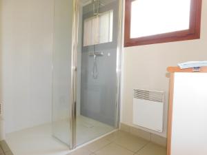 a shower with a glass door in a bathroom at Village de Gîtes de La Chesnaie in Saint-Denis-du-Maine