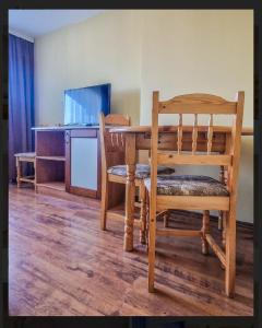 a dining room with a table and two chairs at Къща за гости Карасански in Bansko