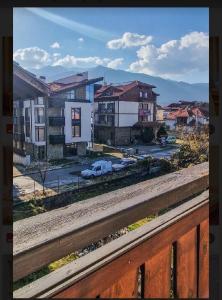 a view from a balcony of a city with buildings at Къща за гости Карасански in Bansko