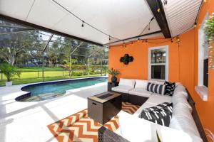 a living room with a couch and a swimming pool at 13 Beach Cottage With Heated Pool In Clearwater in Clearwater