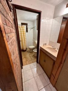 ein Bad mit einem Waschbecken und einem WC in der Unterkunft La Posada de Gogg Cabañas in Bella Vista