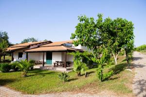 a house on the side of a road at Agriresidence Ninea - First row with seaview in Capo Vaticano