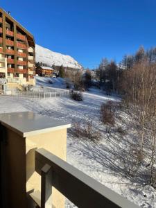 a view from the balcony of a building in the snow at APPARTEMENT PIED DES PISTES-ALPE D'HUEZ-LES BERGERS-1 Chambre-5 personnes in L'Alpe-d'Huez