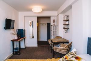a living room with a table and a dining room at Boutique Lodge Zandvoort in Zandvoort