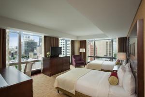 a hotel room with two beds and a balcony at InterContinental Boston by IHG in Boston