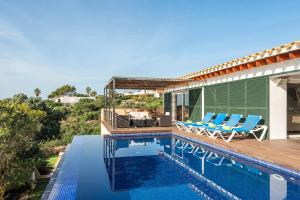 a villa with a swimming pool and a house at Villa Iris Torret by Escape Home in Sant Lluis