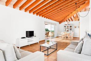 a living room with two couches and a tv at Villa Iris Torret by Escape Home in Sant Lluis