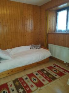 a bedroom with a bed in a wooden room at Appartement Randogne in Crans-Montana