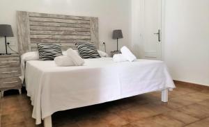 a large white bed with two pillows on it at Hotel Rosamar - Emar Hotels in Es Pujols