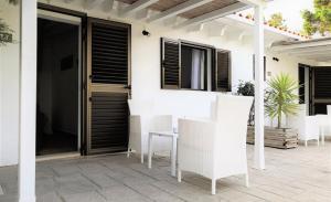 a patio with a table and chairs on a house at Hotel Rosamar - Emar Hotels in Es Pujols
