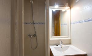 a bathroom with a shower and a sink and a mirror at Hotel Rosamar - Emar Hotels in Es Pujols