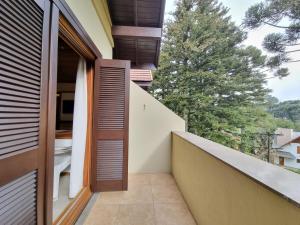 a balcony with a view of a house at APARTAMENTO GRAMADO HOTEL in Gramado +1 photo