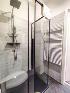 a bathroom with a glass shower and a toilet at Cosy Casa in Budapest