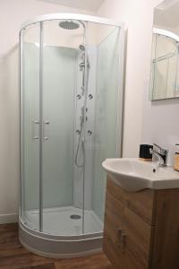 a bathroom with a shower and a sink at L'orchidée #Hyper-centre #Marché couvert in Cognac +7 photos