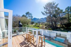 een terras met stoelen en een zwembad op een huis bij Riebeeck Villa - 5 min walk to Franschhoek Central in Franschhoek