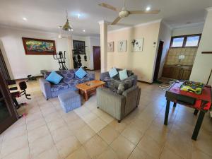 a living room with a couch and a table at MB Apartments & Hotel Medan in Sunggal