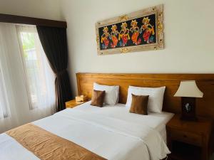 Postel nebo postele na pokoji v ubytování Gangga Guest House