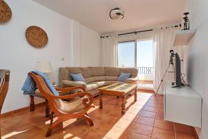 a living room with a couch and a table at Los Altos 19 in La Herradura