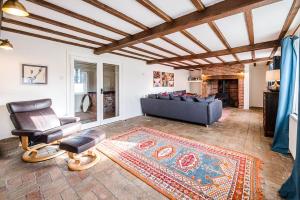 a living room with a couch and a chair at Solebay House in Woodbridge