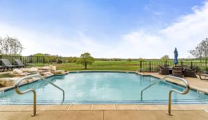 a swimming pool with a golf course in the background at Pursell Farms in Fayetteville