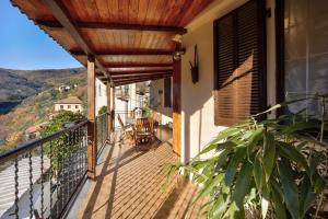 a balcony of a house with a wooden deck at Da Nonna Annetta in Nasino