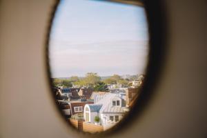 a view of a city seen through a window at Boutique Lodge Zandvoort in Zandvoort