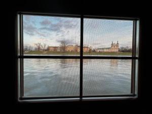 a window with a view of the water at Boat-Hostel "Marta" in Kraków
