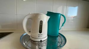 a tea kettle and a cup on a counter at На Тархана in Astana