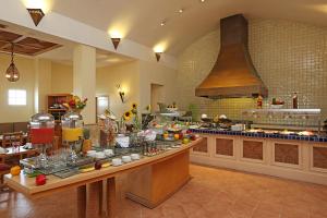 a large kitchen with a buffet in a restaurant at Quality Hotel Real Aeropuerto Santo Domingo in Boca Chica