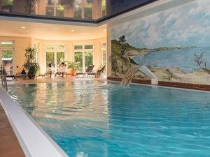a large swimming pool in a house with a painting at Seepark Heidenholz, Plau am See in Plau am See