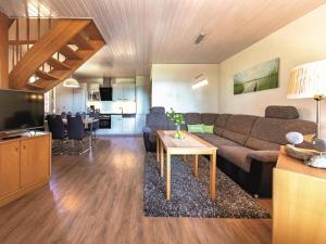 a living room with a couch and a table at Seepark Heidenholz, Plau am See in Plau am See