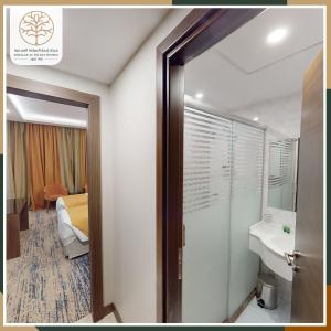 a bathroom with a toilet and a sink and a mirror at Emaar International in Mecca +29 photos