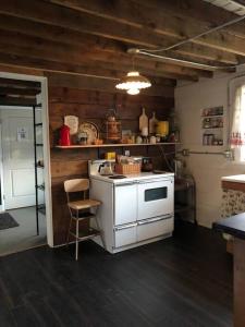 a kitchen with a white stove and a sink at The Schoolhouse vintage home on the farm 
