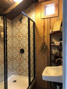 a bathroom with a shower and a sink at The Schoolhouse vintage home on the farm 